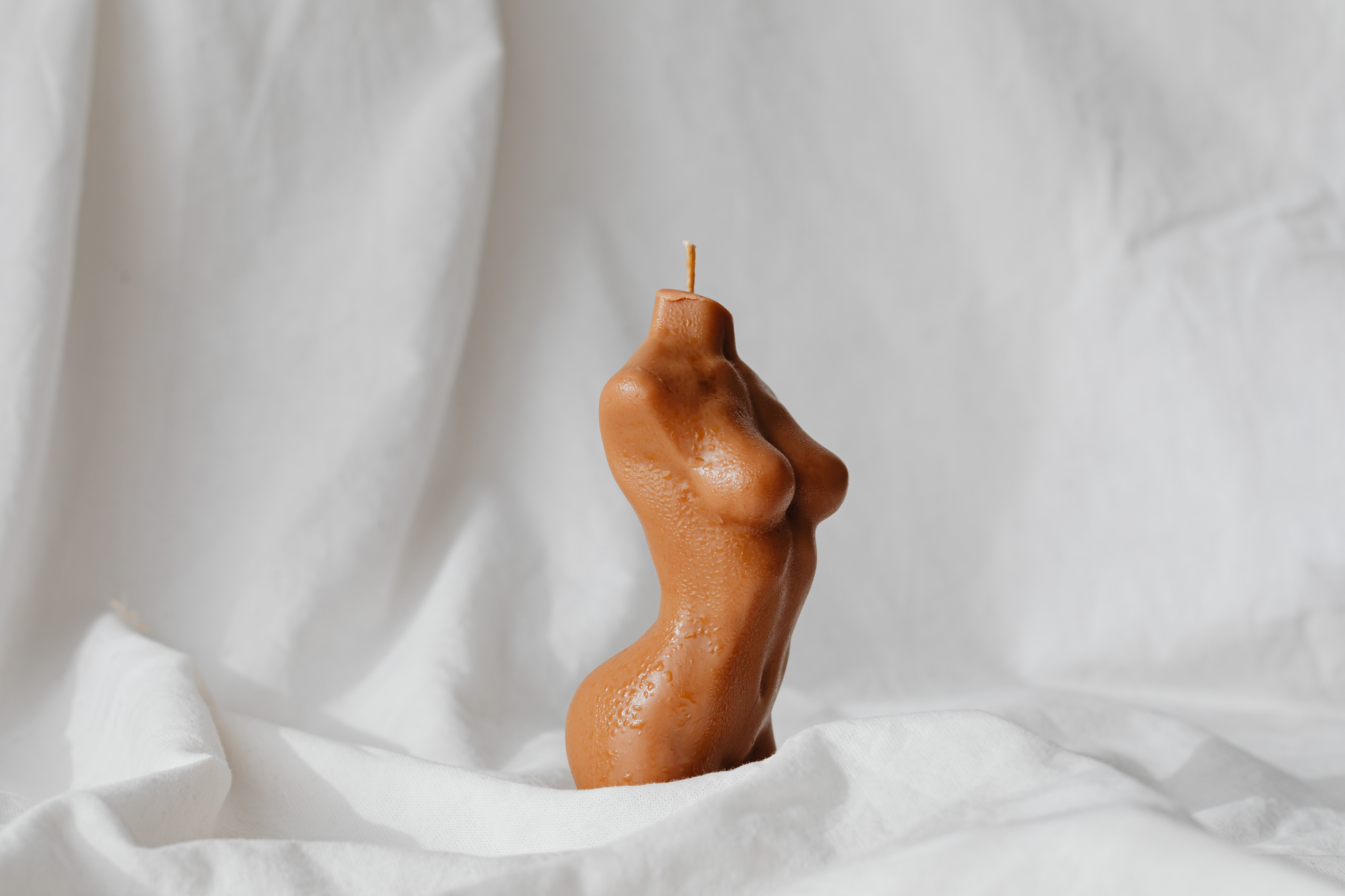 Candle in a Shape of Female Body and White Drape
